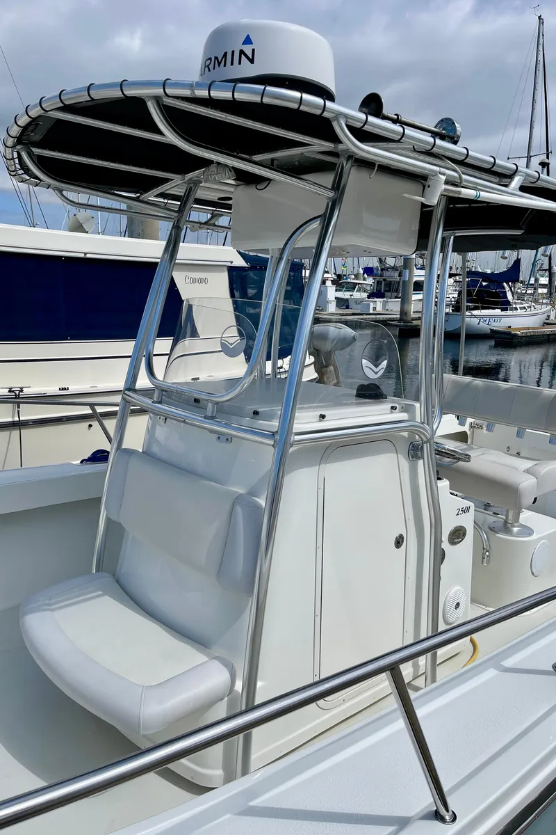 Slide: The Image of 2016 Parker 2501 Center Console boat with T-top, docked in marina. - 27