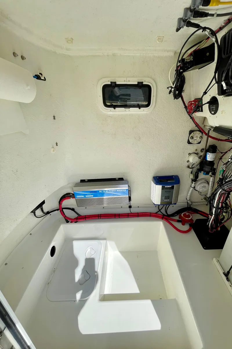 Slide: The Image of Interior view of a 2016 Parker 2501 Center Console boat, showcasing wiring and equipment. - 29