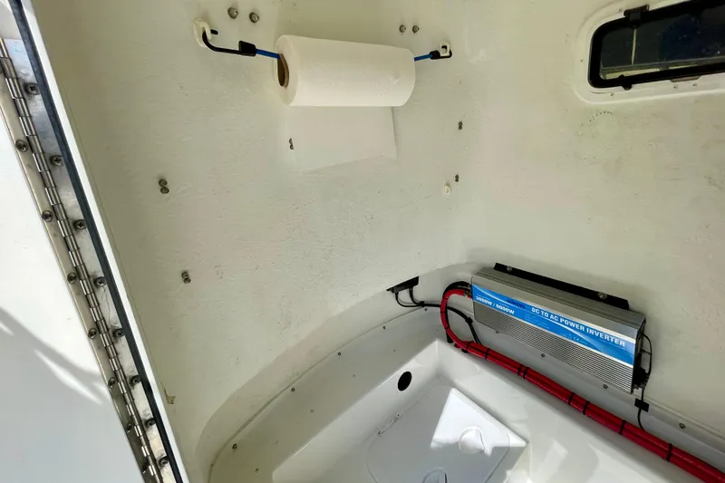 Slide: The Image of 2016 Parker 2501 Center Console interior with paper towel holder and power inverter. - 30