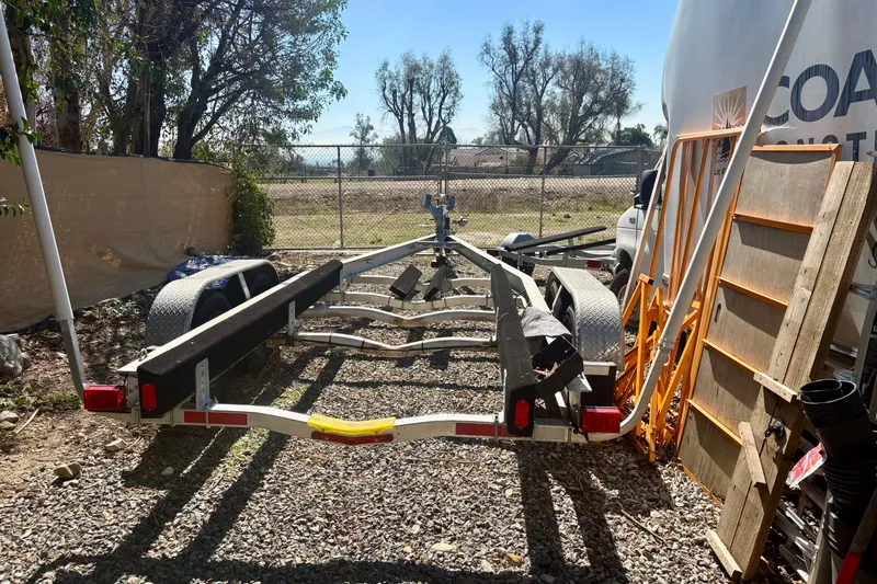 Slide: The Image of Trailer for 2016 Parker 2501 Center Console boat parked outdoors. - 34