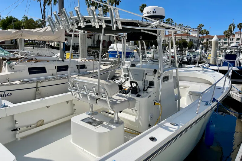 Slide: The Image of 2016 Parker 2501 Center Console boat docked in marina, featuring Garmin equipment. - 5