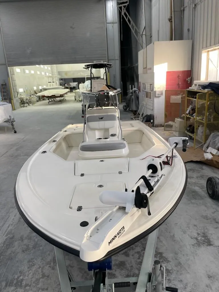 Slide: The Image of 2024 Mako 18 LTS boat in a workshop, featuring a sleek white design. - 4