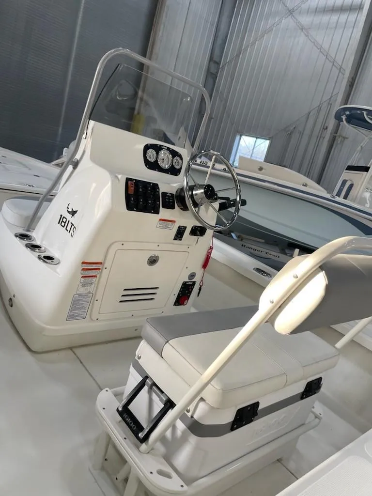 Slide: The Image of 2024 Mako 18 LTS boat interior with steering console and seating. - 6