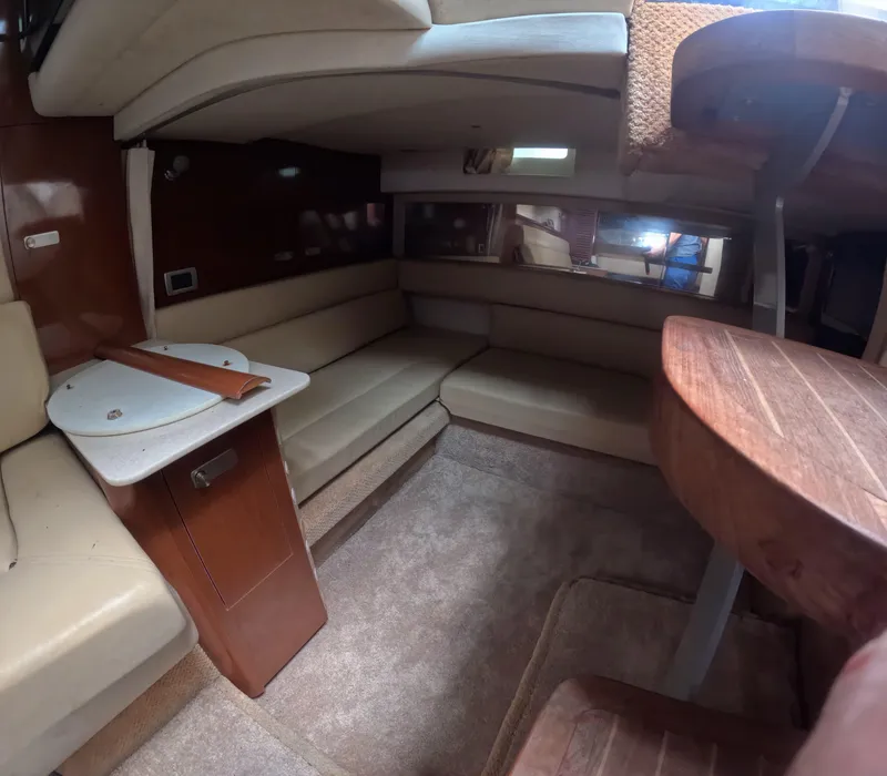 Slide: The Image of Interior of 2010 Sea Ray 38 yacht with beige seating and wooden accents. - 11