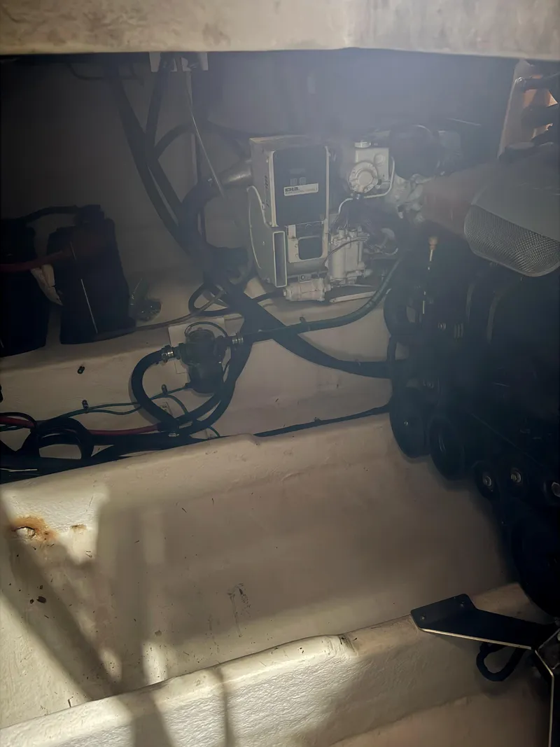 Slide: The Image of Engine compartment of a 2010 Sea Ray 38 boat, showing mechanical components and wiring. - 12