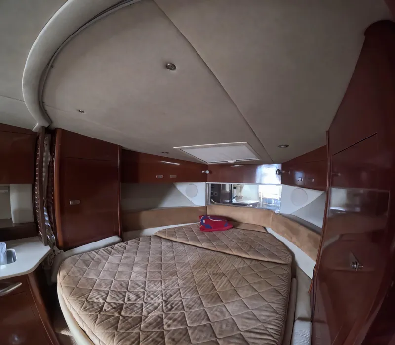 Slide: The Image of Luxurious cabin interior of 2010 Sea Ray 38 yacht with cozy bed and wood finish. - 15