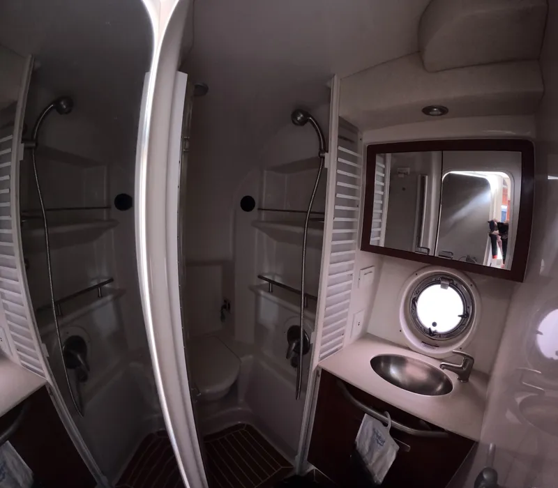 Slide: The Image of Bathroom interior of 2010 Sea Ray 38 yacht with shower, sink, and porthole window. - 16