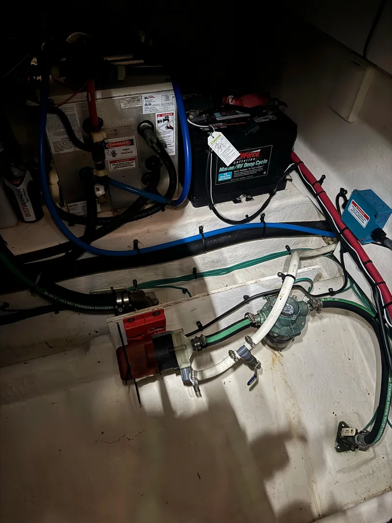 Slide: The Image of Engine compartment of a 2010 Sea Ray 38 boat, showing battery and wiring. - 18