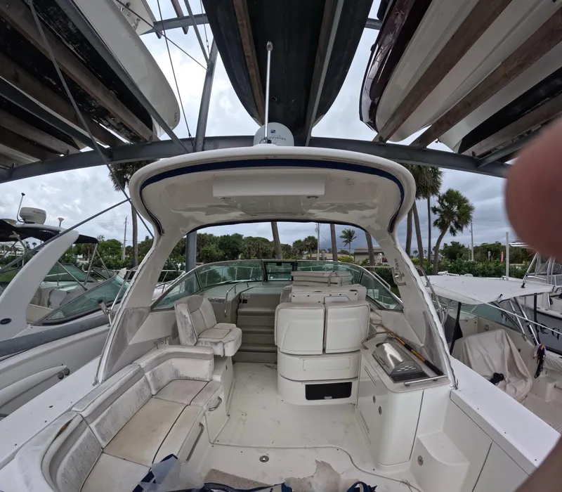 Slide: The Image of 2010 Sea Ray 38 yacht interior with seating and helm, docked under a canopy. - 4