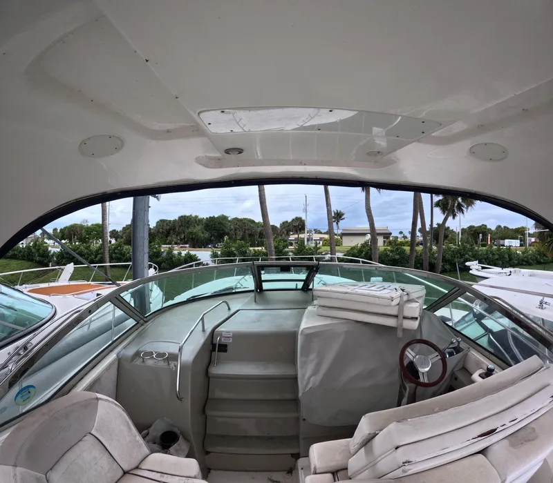 Slide: The Image of Interior view of a 2010 Sea Ray 38 yacht with seating and steering wheel. - 5