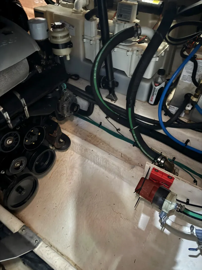 Slide: The Image of Engine compartment of a 2010 Sea Ray 38 boat, showing mechanical components and hoses. - 8