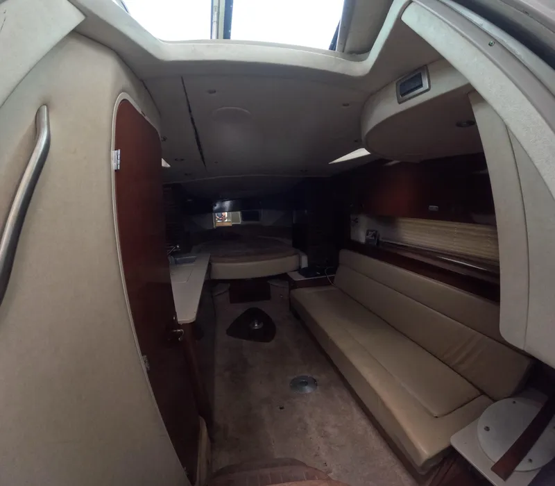 Slide: The Image of Interior of 2010 Sea Ray 38 yacht, featuring seating and sleeping area. - 9