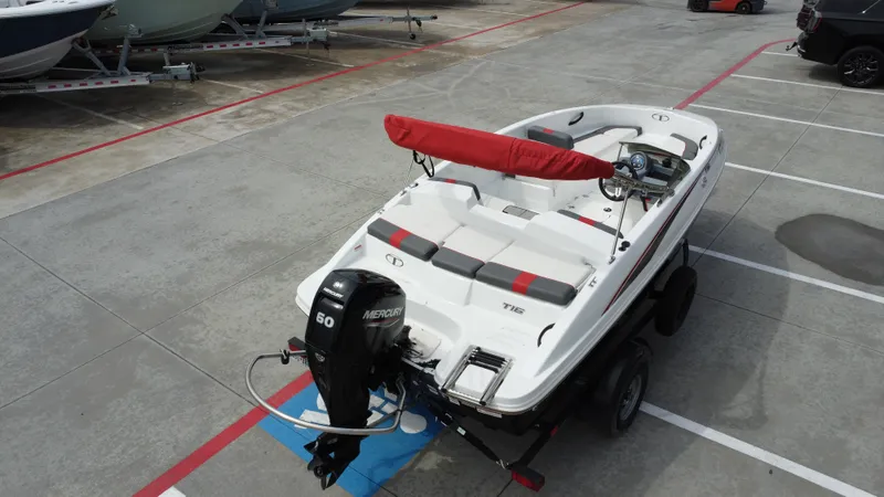 Slide: The Image of 2021 TAHOE TAHT16 boat with Mercury 60 engine on trailer in parking lot. - 11