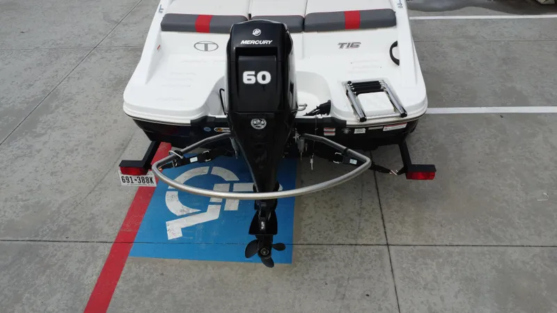 Slide: The Image of 2021 TAHOE TAHT16 boat with Mercury 60 engine parked in a handicap space. - 22
