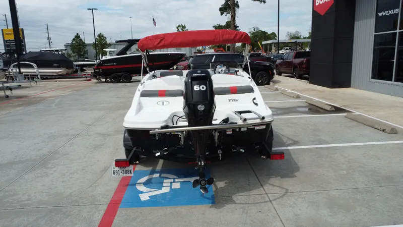 Slide: The Image of 2021 TAHOE TAHT16 boat with red canopy parked in a dealership lot. - 9