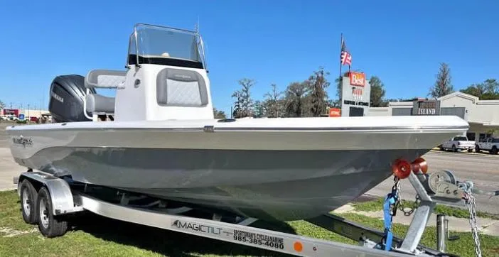 The Image of 2025 NauticStar 224 Bay boat on trailer, parked outdoors. - 0