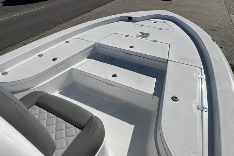 Slide: The Image of 2025 NauticStar 224 Bay boat interior with seating and storage compartments. - 6