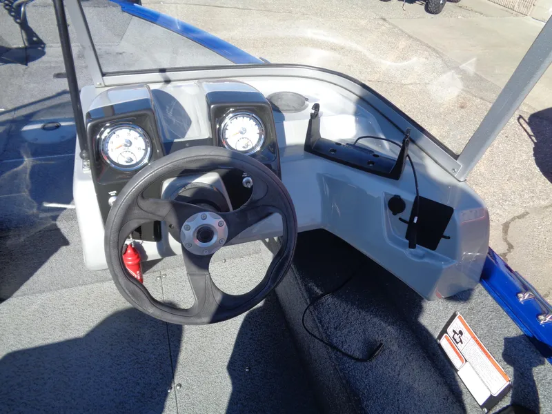 Slide: The Image of 2018 Tracker Pro Guide V-16 WT boat dashboard with steering wheel and gauges. - 10