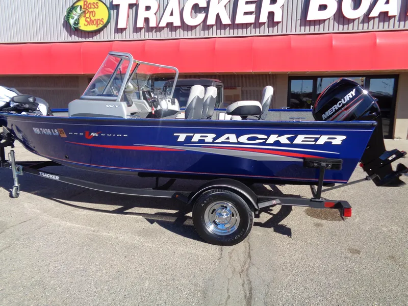 Slide: The Image of 2018 Tracker Pro Guide V-16 WT boat with Mercury engine at Bass Pro Shops. - 2