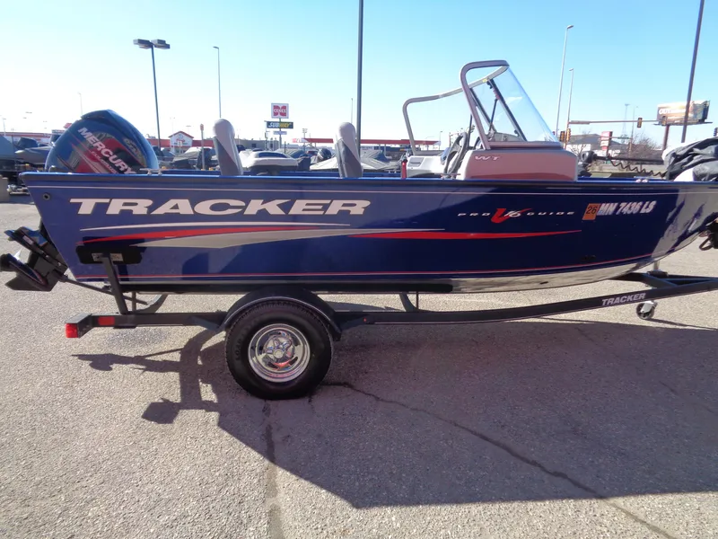Slide: The Image of 2018 Tracker Pro Guide V-16 WT boat on trailer in parking lot. - 4