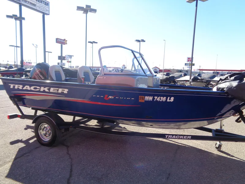 Slide: The Image of 2018 Tracker Pro Guide V-16 WT boat on trailer in outdoor dealership lot. - 5