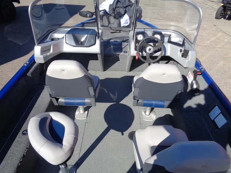 Slide: The Image of 2018 Tracker Pro Guide V-16 WT boat interior with seating and steering console. - 7
