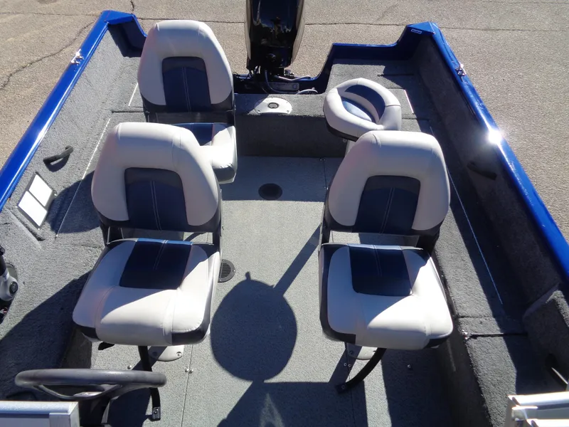 Slide: The Image of 2018 Tracker Pro Guide V-16 WT boat interior with four seats and steering wheel. - 8