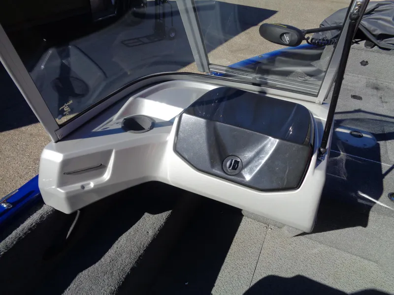 Slide: The Image of 2018 Tracker Pro Guide V-16 WT boat interior with windshield and storage compartment. - 9
