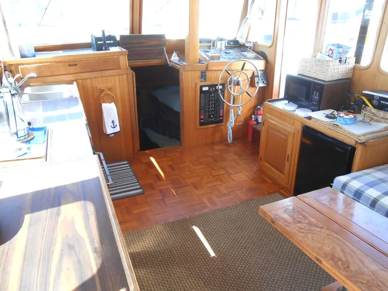 Slide: The Image of Interior of a 1983 Californian 42 yacht with wooden furnishings and nautical decor. - 10
