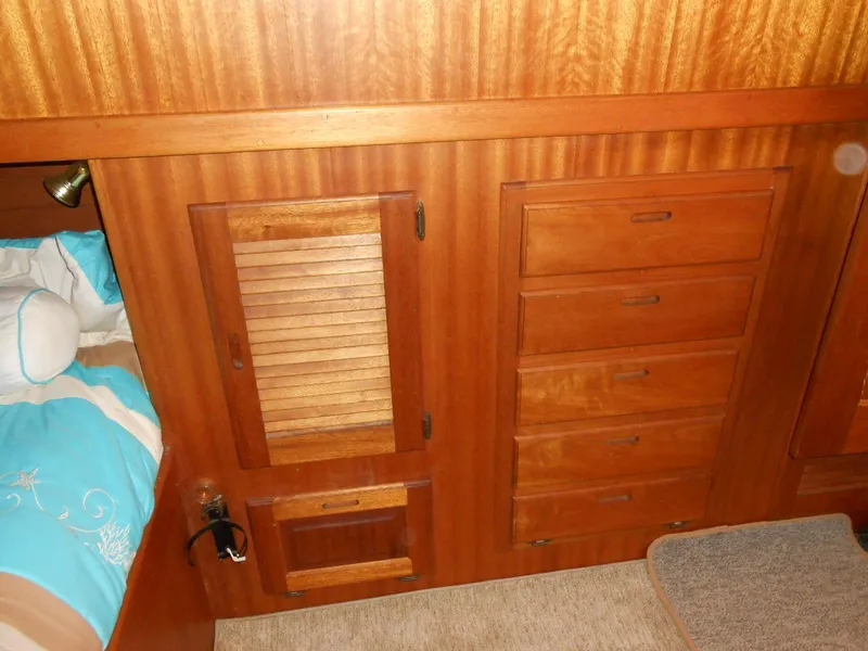 Slide: The Image of Wooden cabinetry in a 1983 Californian 42 yacht interior, featuring drawers and louvered doors. - 14
