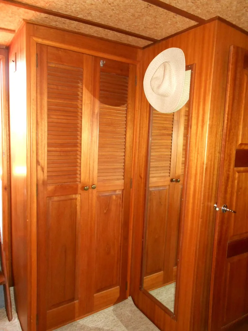 Slide: The Image of Wooden interior of 1983 Californian 42 boat with hat on closet door. - 15