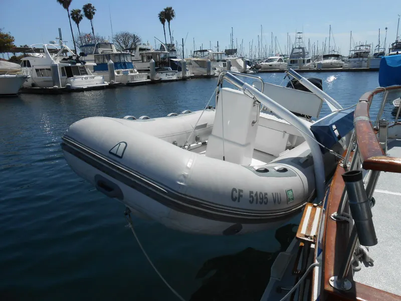 Slide: The Image of Inflatable boat docked beside a 1983 Californian 42 yacht in a marina. - 5