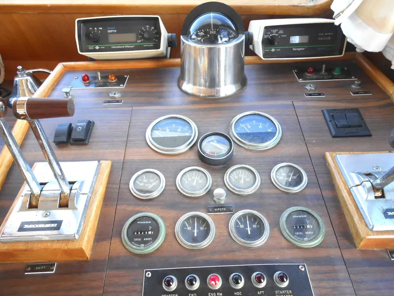 Slide: The Image of 1983 Californian 42 boat dashboard with gauges, controls, and compass. - 6
