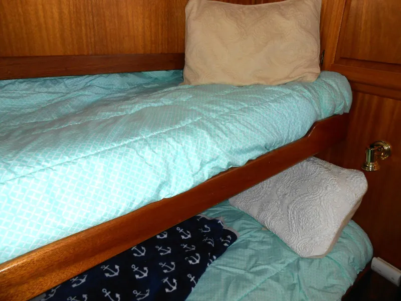 Slide: The Image of Bunk beds with blue bedding in a 1983 Californian 42 yacht cabin. - 8