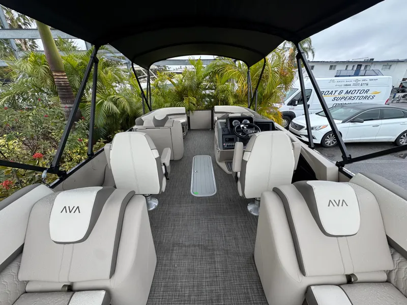 Slide: The Image of 2025 Avalon Catalina Quad Lounge boat interior with plush seating and canopy. - 15