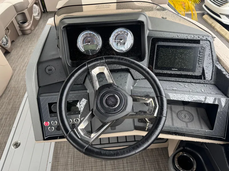 Slide: The Image of Steering console of 2025 Avalon Catalina Quad Lounge boat, featuring modern controls and gauges. - 19