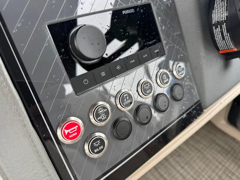 Slide: The Image of Control panel of 2025 Avalon Catalina Quad Lounge boat with buttons and dials. - 20