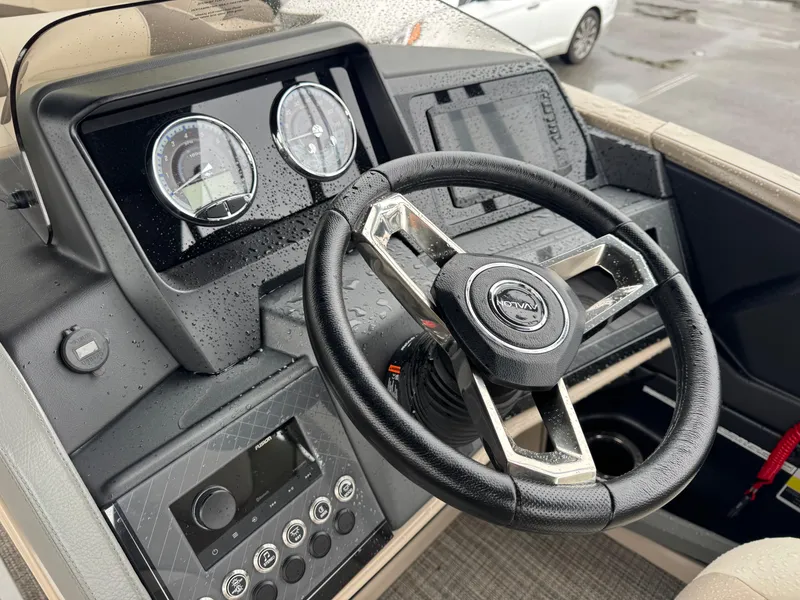 Slide: The Image of Steering console of 2025 Avalon Catalina Quad Lounge boat, featuring modern controls and gauges. - 21