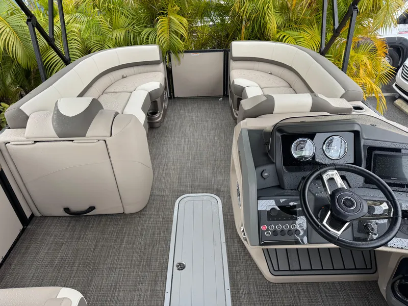 Slide: The Image of 2025 Avalon Catalina Quad Lounge boat interior with plush seating and modern dashboard. - 22