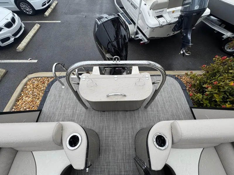 Slide: The Image of 2025 Avalon Catalina Quad Lounge boat with motor, parked in a lot. - 36