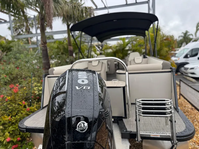 Slide: The Image of 2025 Avalon Catalina Quad Lounge boat with powerful V8 engine, parked outdoors. - 4