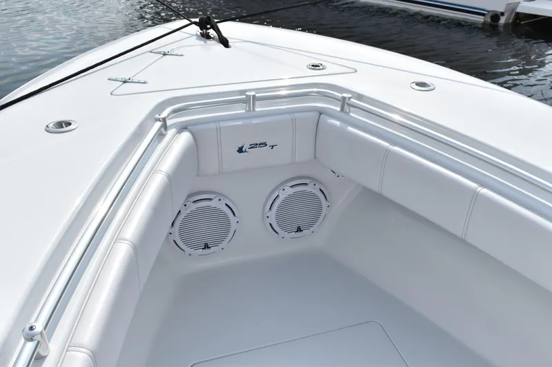 Slide: The Image of 2025 Contender 25T boat interior with white seating and built-in speakers. - 11