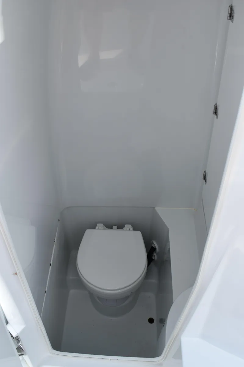 Slide: The Image of 2025 Contender 25T boat interior with compact marine toilet. - 21