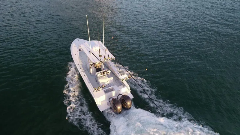 Slide: The Image of 2025 Contender 25T boat cruising on open water, aerial view. - 5