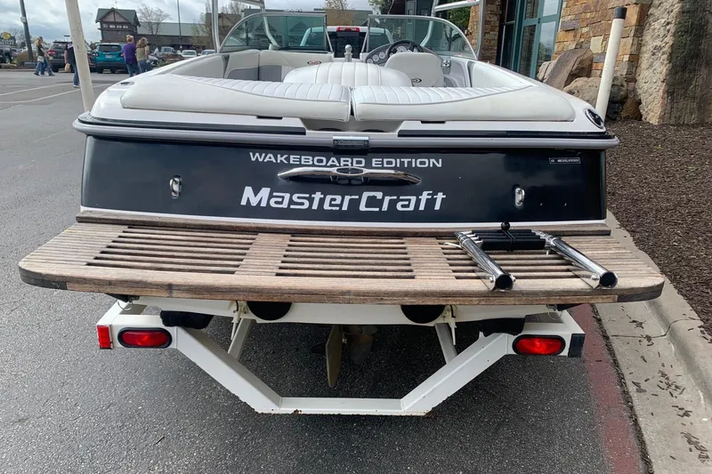 Slide: The Image of 2000 MasterCraft X5 Wakeboard Edition boat, rear view with swim platform and ladder. - 2