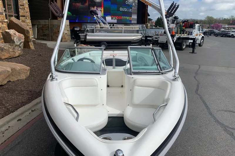 Slide: The Image of 2000 MasterCraft X5 boat with white interior, parked outdoors. - 3