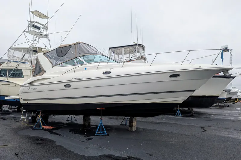Slide: The Image of 2006 Cruisers Yachts 320 Express on stands in a boatyard. - 1