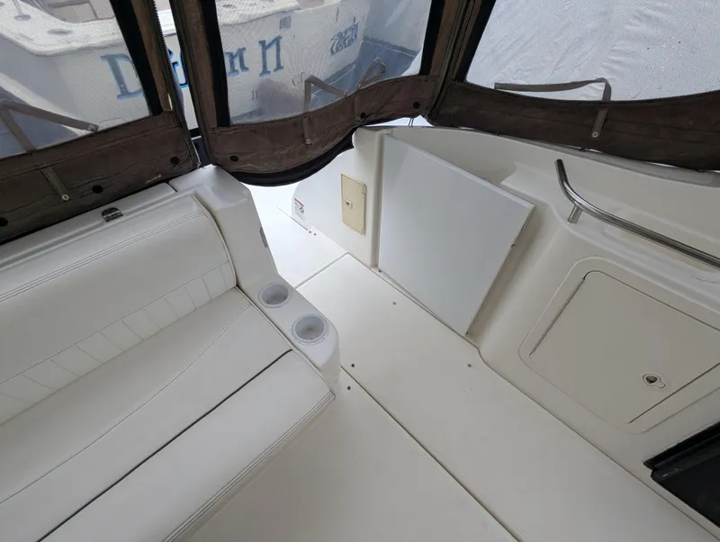 Slide: The Image of 2006 Cruisers Yachts 320 Express interior with white seating and cup holders. - 10