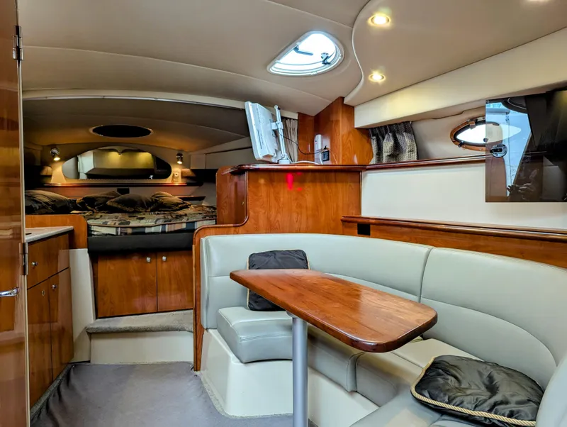 Slide: The Image of 2006 Cruisers Yachts 320 Express interior with cozy seating and elegant wood finishes. - 11