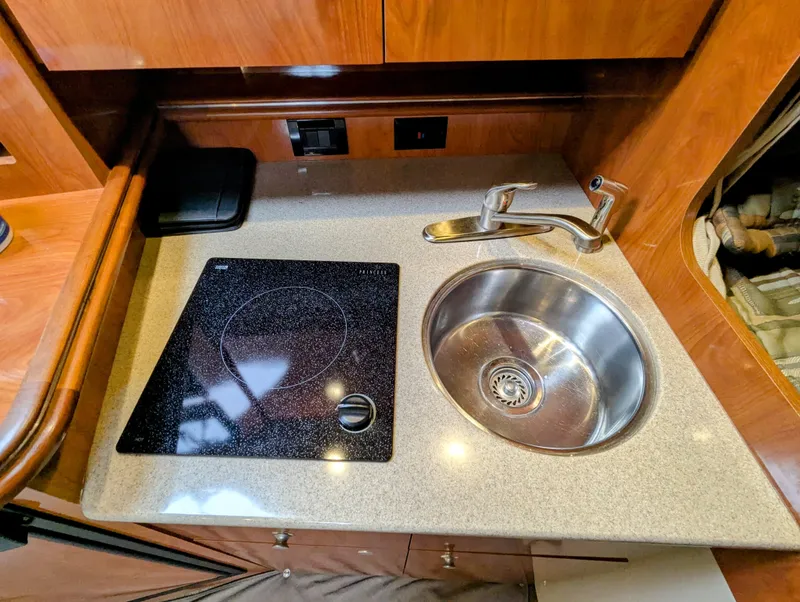 Slide: The Image of 2006 Cruisers Yachts 320 Express kitchen with sink and stovetop. - 14